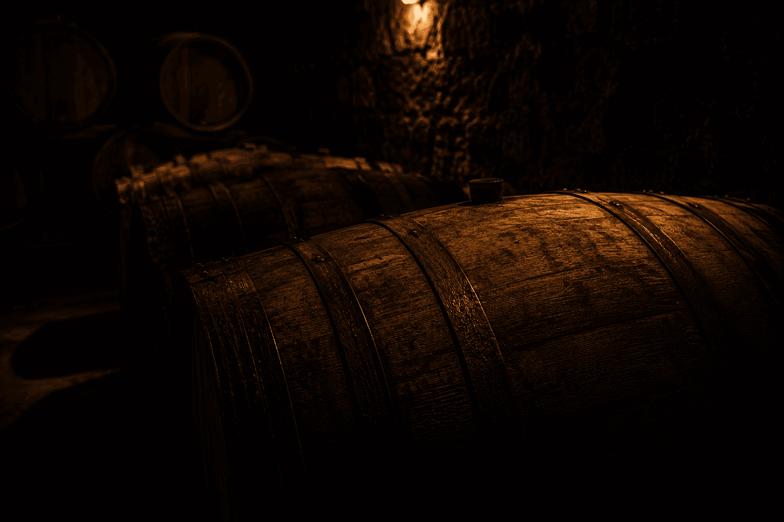 Oak barrels resting in low light